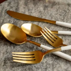 Mazzy Gold Satin White Pom Handle 20-Piece Flatware Set